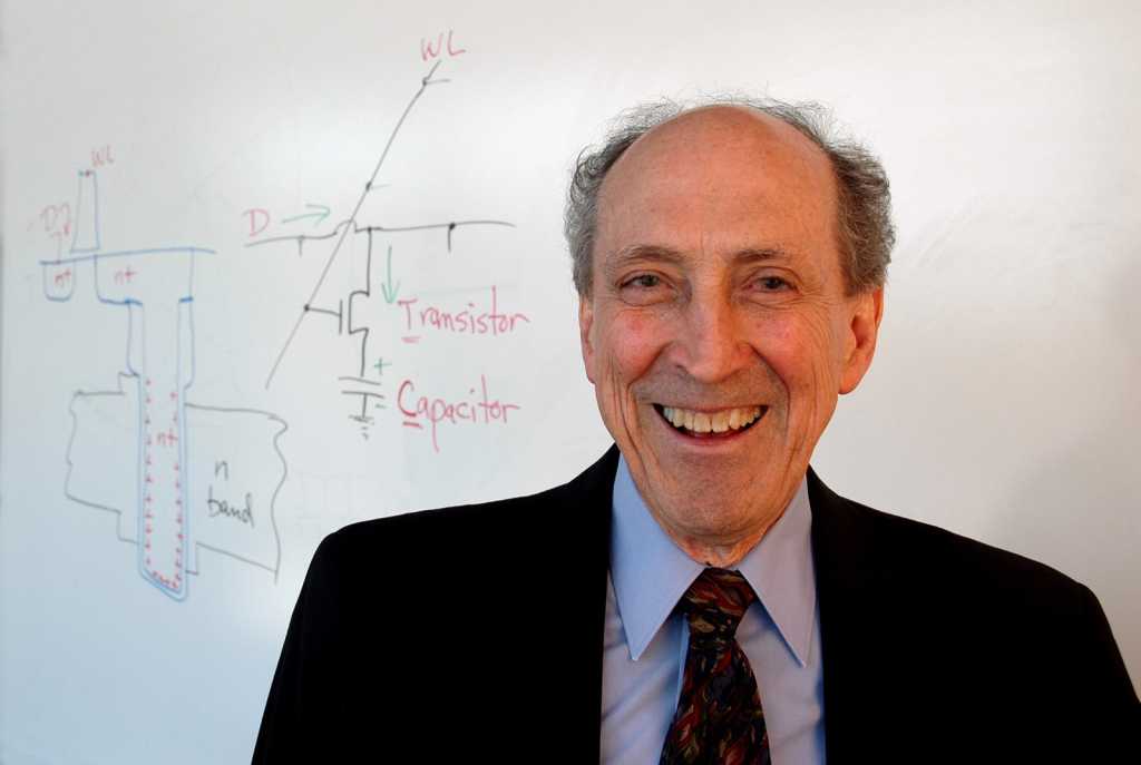 robert dennard in front of whiteboard with diagram