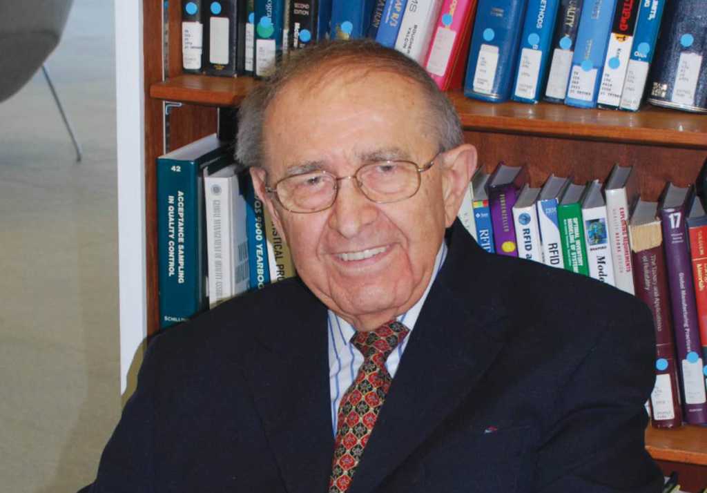 photo of lubomyr romankiw in front of a bookshelf