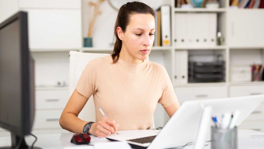 Mitarbeiterin am PC und Notebook