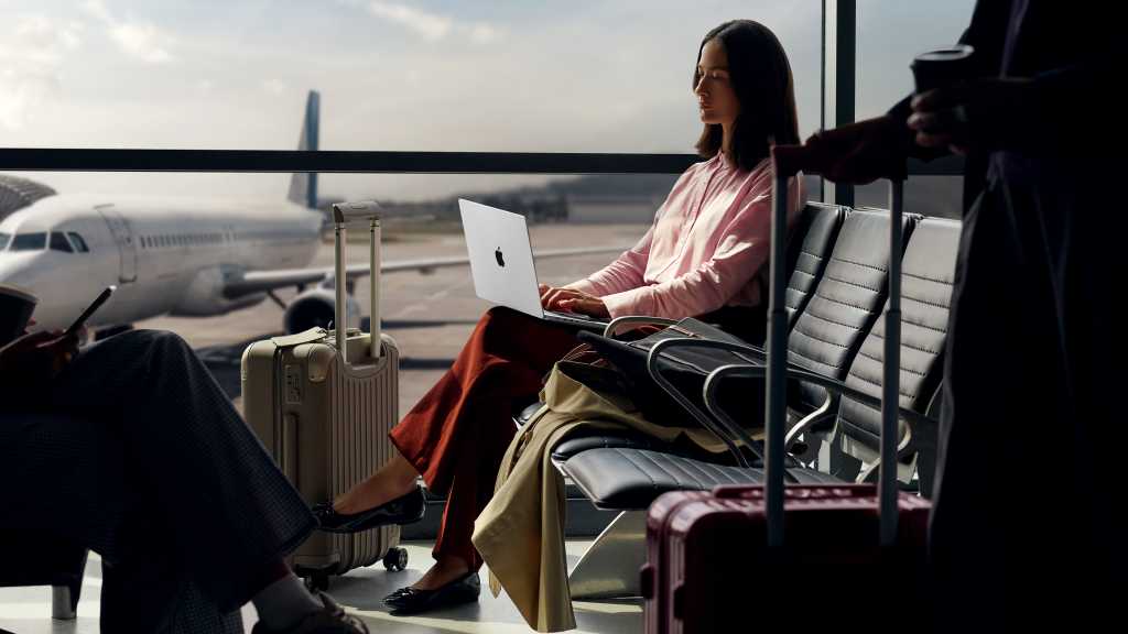 Woman working on a Mac in an airport