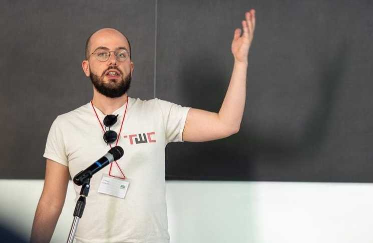 photo of simone robutti of tech workers coalition global giving a lecture in front of a blackboard