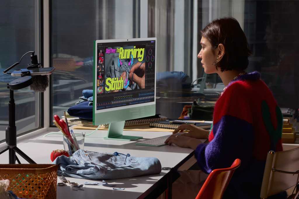 A woman working at her new iMac.